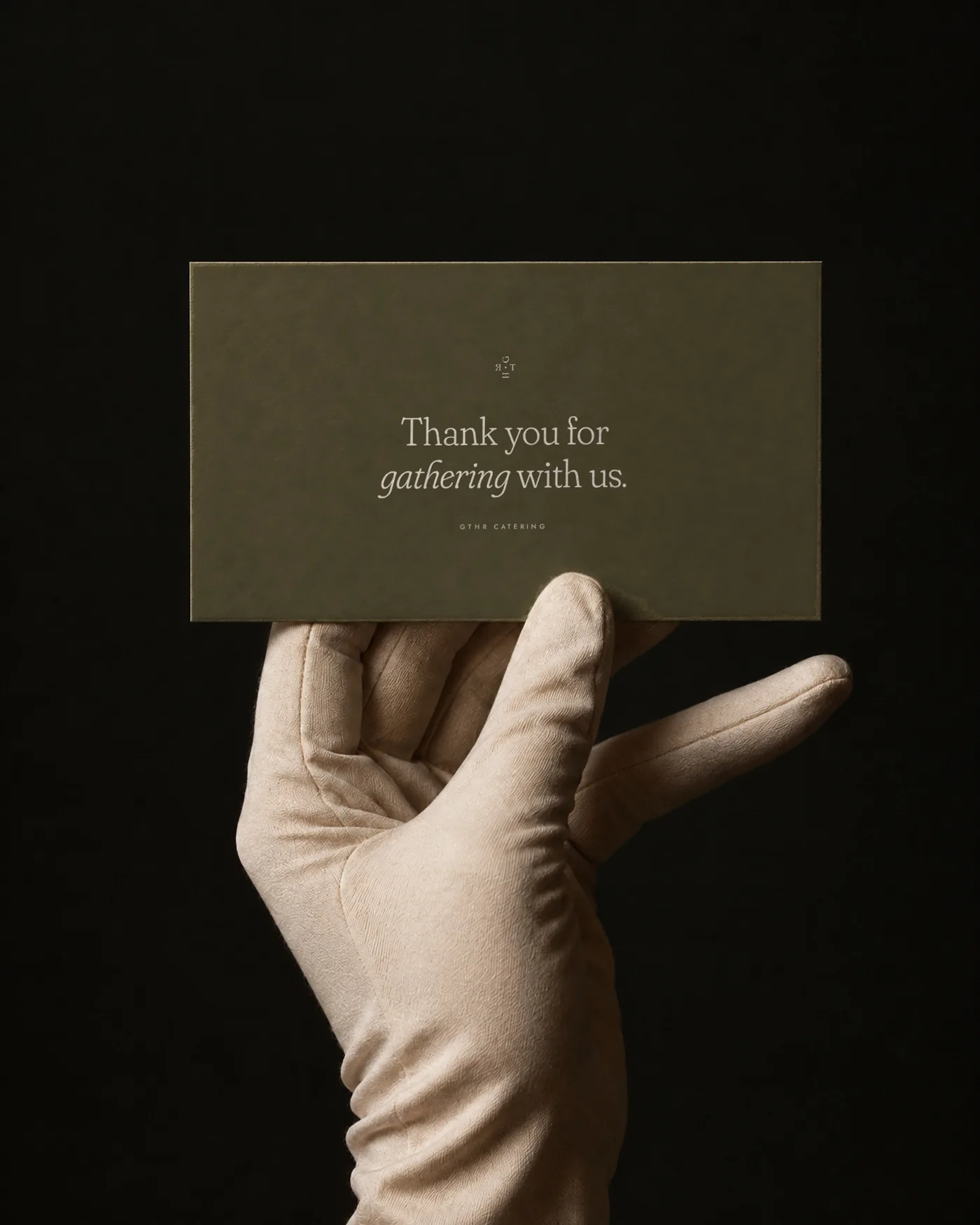 Olive thank-you card held in a gloved hand
